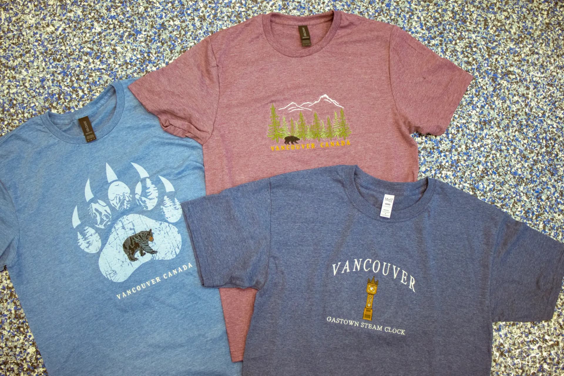 Embroidered Cowichan shirts folded in a stack