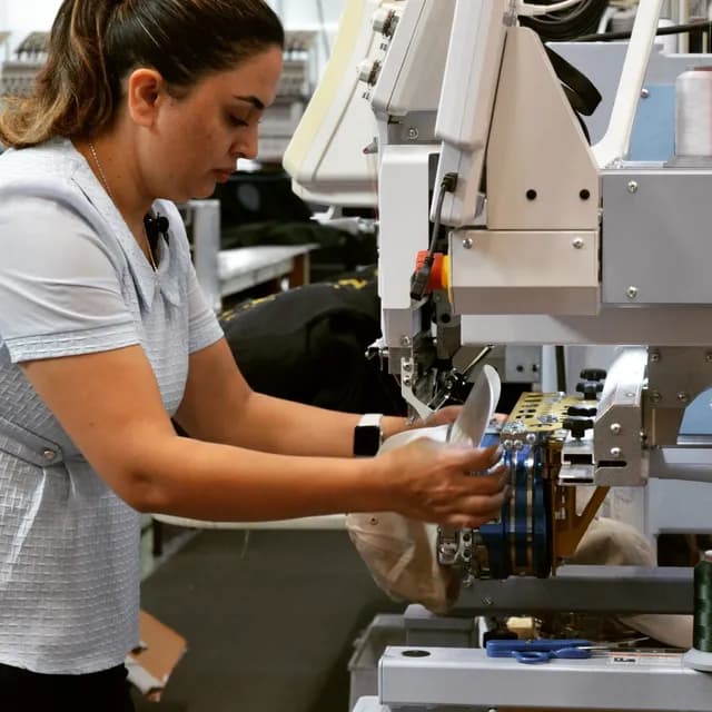 Cowichan worker preparing garments at the workshop