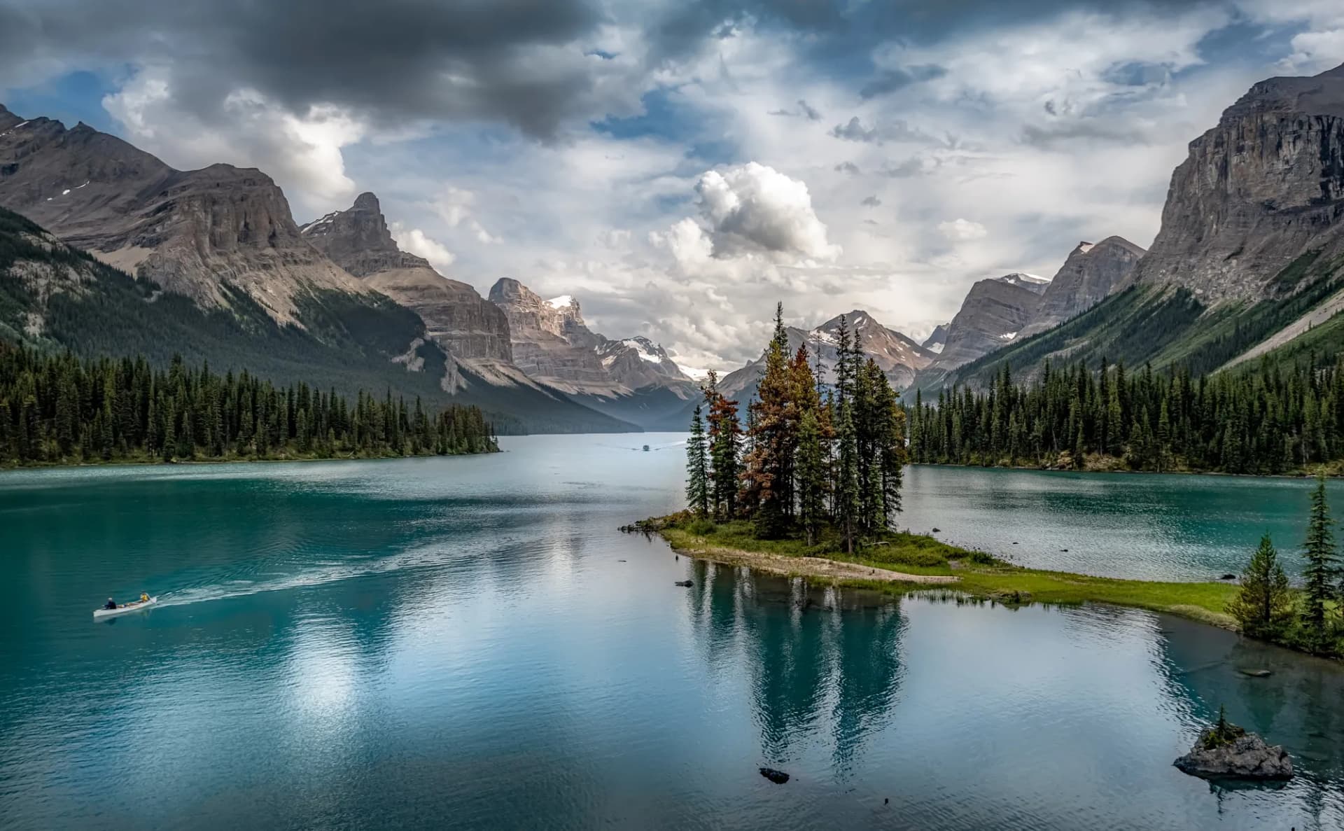 Spirit Island on Maligne Lake in Jasper National Park, a small treed island in turquoise water below grey peaks